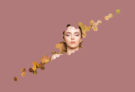 Portrait of young, natural and healthy woman over autumn leaves background. Healthcare, spa, makeup...