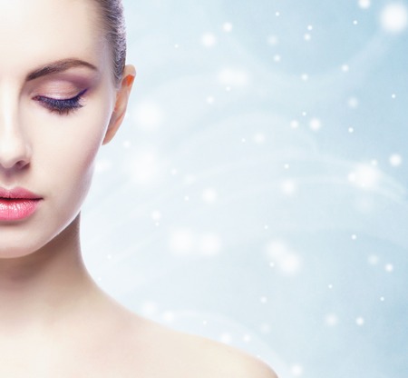 Portrait of young, beautiful and healthy woman over winter Christmas background.の写真素材