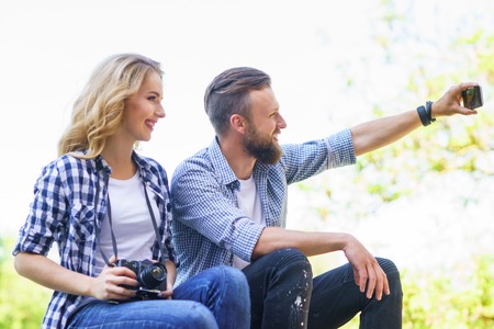 Young loving couple making selfie photo outdoor.の写真素材