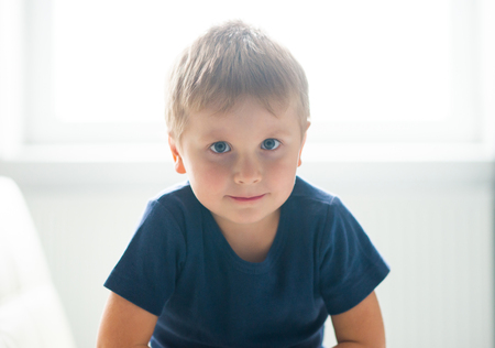 Portrait of happy smiling boy. Attractive kid at home.の写真素材