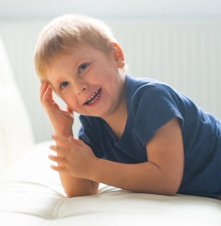 Portrait of happy smiling boy. Attractive kid at home.の写真素材