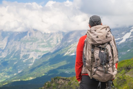 Hiker traveling in Alps. Alpine peaks landskape background. Jungfrau, Bernese highland. Sport, tourism and hiking concept.の写真素材