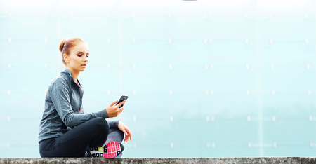 Young, fit and sporty brunette girl in sportswear. Woman doing sports outdoor.の写真素材