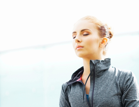 Young, fit and sporty brunette girl in sportswear. Woman doing sports outdoor.の写真素材