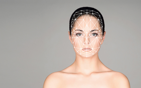 Portrait of attractive woman with a scnanning grid on her face. Face id, security, facial recognition, future technology.の写真素材