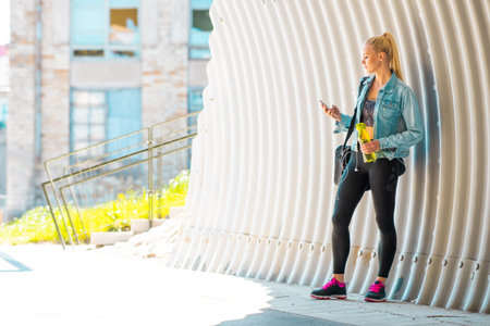 Attractive woman in sportswear walking to a gym outdoor. Sport, jogging, healthy and active...