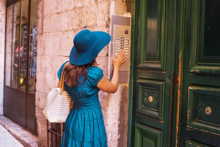 Young and beautiful brunette girl in dress and hat walking outdoor in the street. Nice, France. Summer vacation, traveling and tourism.の写真素材