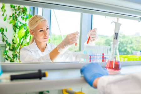 Scientist and students working in lab. Doctor teaching interns to make blood analyzing research....