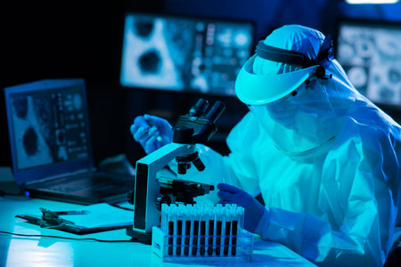 Scientist in protection suit and masks working in research lab using laboratory equipment:...
