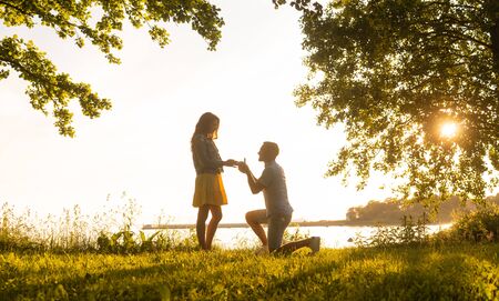 Loving man making a wedding offer to his beautiful girlfriend. Be my wife concept.の写真素材