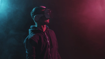 Portrait of a man in virtual reality helmet. Obscured dark face in VR goggles. Internet, darknet,...