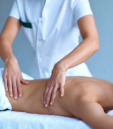 Close-up of traditional healing and recreation massaging treatments. Young woman in spa. Health, skin care, massage, osteopathy and manual therapy concept.の写真素材
