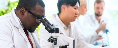 Scientist and students working in lab. Doctor teaching interns to make analyzing research. Biotechnology, chemistry, bacteriology, virology, dna and health care concept.の写真素材