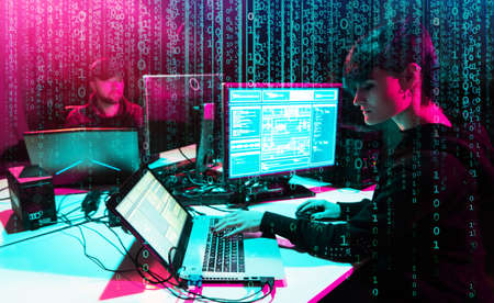Hackers are breaking server using computers. Cybercrime concept.の写真素材