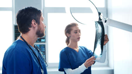 Professional medical doctors working in emergency medicine. Portrait of the surgeon and the nurse preparing for a surgical operation.の写真素材