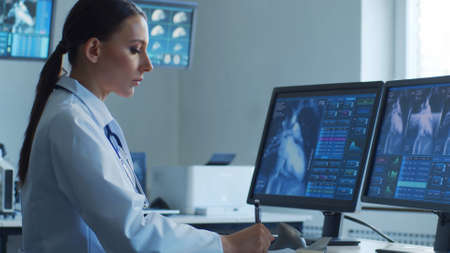 Professional medical doctors are maksing computer research in hospital office. Medicine, healthcare and cardiology concepts.の写真素材