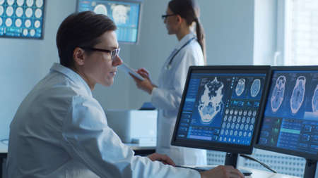 Professional medical doctors are maksing computer research in hospital office. Medicine, healthcare and neurosurgery concepts.の写真素材