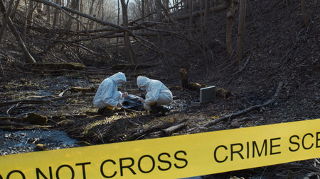 Detectives are collecting evidence in a crime scene. Forensic specialists are making expertise....