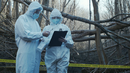 Detectives are collecting evidence in a crime scene. Forensic specialists are making expertise....