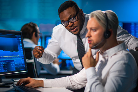 Team of brokers is working in office using workstation and analysis technology. Workplace of professional traders. Global financial markets, business, currency exchange and banking concepts.の写真素材