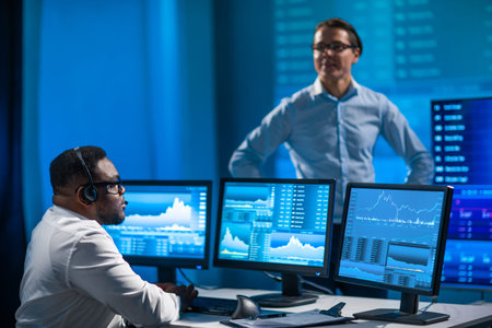 Team of brokers is working in office using workstation and analysis technology. Workplace of...