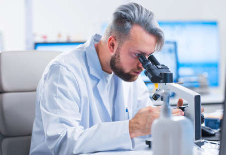 Professional scientist is working on a vaccine in a modern scientific research laboratory. Genetic engineer workplace. Future technology and science.の写真素材