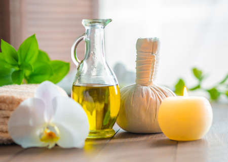 Spa background. Towel, candles, orchid flowers and herbal balls. Massage, oriental therapy, wellbeing and meditation.の写真素材