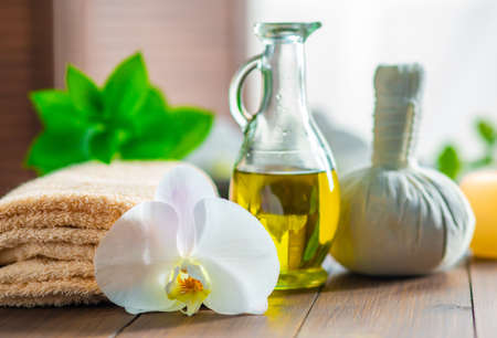 Spa background. Towel, candles, orchid flowers and herbal balls. Massage, oriental therapy, wellbeing and meditation.の写真素材