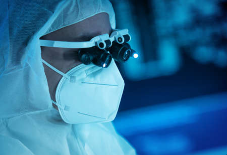 The scientist works in a modern scientific laboratory for the research and development of microelectronics and processors. Microprocessor manufacturing worker uses computer technology and equipment.の写真素材