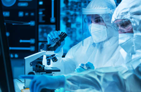 Scientists work in a modern scientific lab using laboratory equipment, microscope and computer technology. Invention of new vaccines. Concept of Science and Health.の写真素材