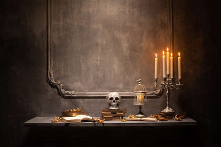 Scary laughing pumpkin and old skull on ancient gothic fireplace. Halloween, witchcraft and magic.の写真素材