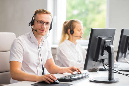 Diverse team of young professionals is working in the phone support office. Working day of sales managers in the call center. Business, telephone consulting and problem solving.の写真素材