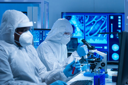 African-american scientist works in a scientific lab using laboratory equipment, microscope and computer technology. Invention of new drugs and vaccines. Concept of Science and Health.の写真素材