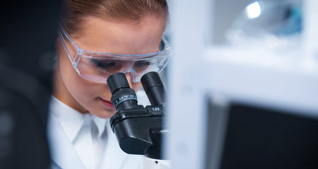 Female doctor works in a modern scientific laboratory using equipment and computer technologies. The...