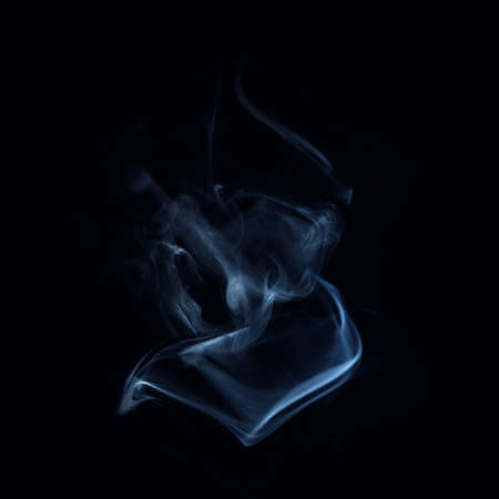 Smoke over black background. Fog or steam texture.の写真素材