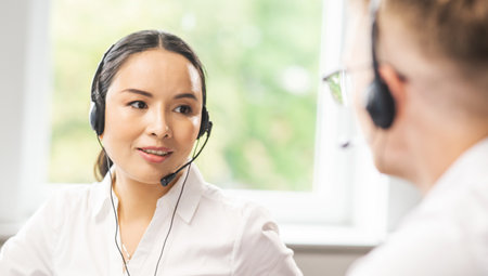 Team of professional support staff working in the office. Colleagues in the workplace solve customer problems. Call center and customer support concept.の写真素材