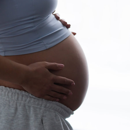 Young pregnant woman is resting at home and expecting a baby. Pregnancy, motherhood, health care and...