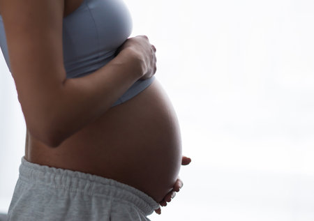 Young pregnant woman is resting at home and expecting a baby. Pregnancy, motherhood, health care and lifestyle concept.の写真素材