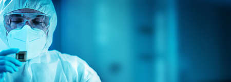 The scientist works in a modern scientific laboratory for the research and development of microelectronics and processors. Microprocessor manufacturing worker uses computer technology and equipment.の写真素材