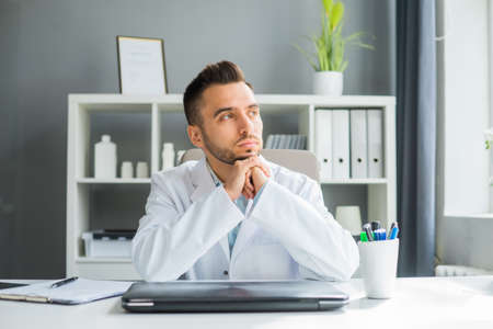 Doctor Works in the Medical Office. Workplace of a Professional Therapist in a Hospital or Clinic. The Concept of Healthcare and Medicine.の写真素材