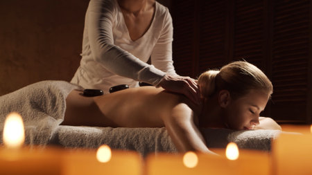 Young, healthy and beautiful woman gets massage therapy in the spa salon. Healthy lifestyle and body care concept.の写真素材