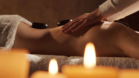 Young, healthy and beautiful woman gets massage therapy in the spa salon. Healthy lifestyle and body care concept.の写真素材