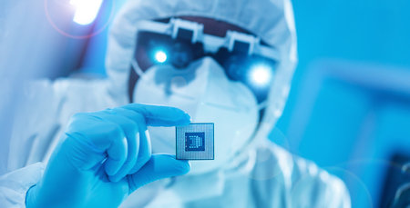 African-American scientist works in a modern scientific laboratory for the research and development of microelectronics and processors. Manufacturing worker uses computer technology and equipment.の写真素材