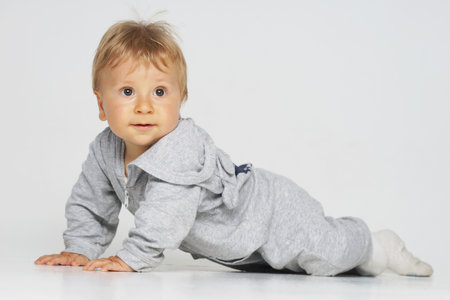 Little, happy and smiling cute baby in the studio. Portrait of a one year old baby. The concept of happiness.の写真素材
