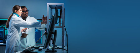 Group of microelectronic engineers discussing in a modern microprocessor manufacture lab. Workplace of electronics designers. The concept of innovations and inventions.の写真素材