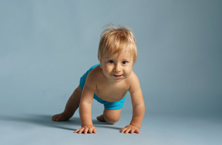 Little, happy and smiling cute baby in the studio. Portrait of a one year old baby. The concept of happiness.の写真素材