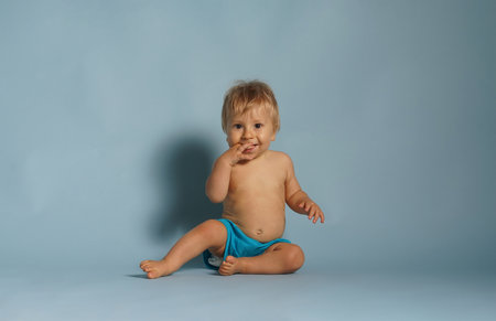 Little, happy and smiling cute baby in the studio. Portrait of a one year old baby. The concept of happiness.の写真素材