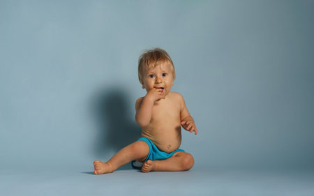 Little, happy and smiling cute baby in the studio. Portrait of a one year old baby. The concept of...