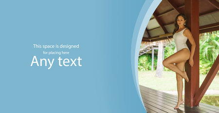 Young and beautiful woman in white swimsuit. Woman posing in exotic Thai bungalow. Resting and traveling concept.の写真素材