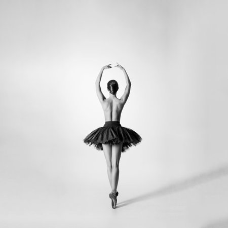 Ballet dancer isolated on white. Beautiful ballerina performing in studio.の写真素材